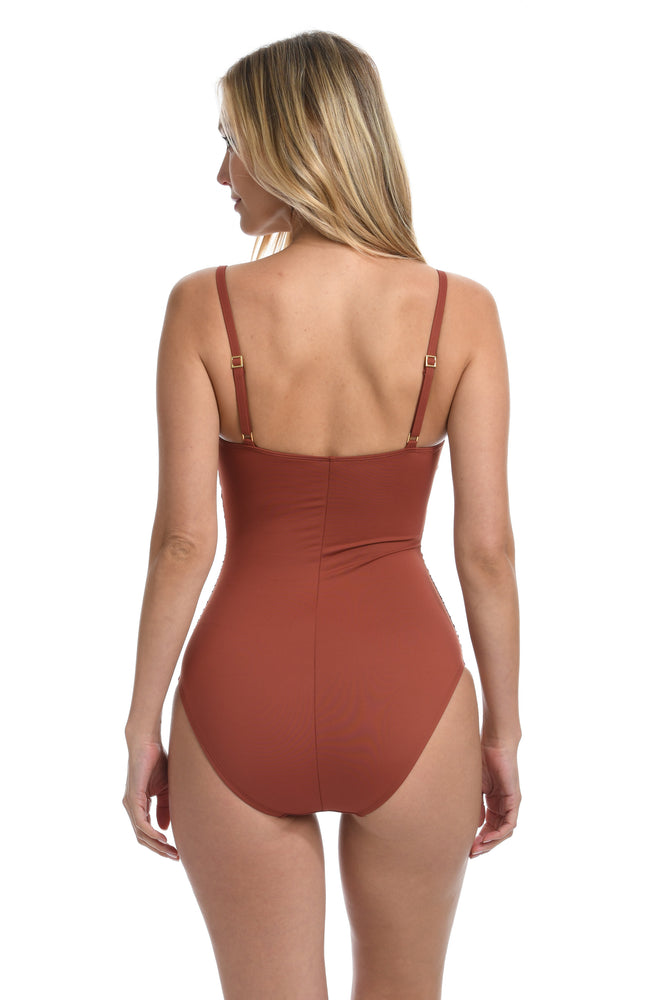Model is wearing a cinnamon colored one piece swimsuit from our Best-Selling Island Goddess collection.