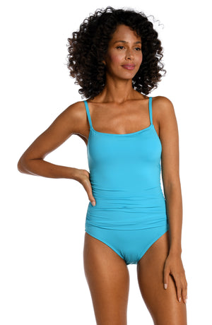 
            
                Load image into Gallery viewer, Model is wearing a azul (light blue) colored one piece swimsuit from our Best-Selling Island Goddess collection.
            
        