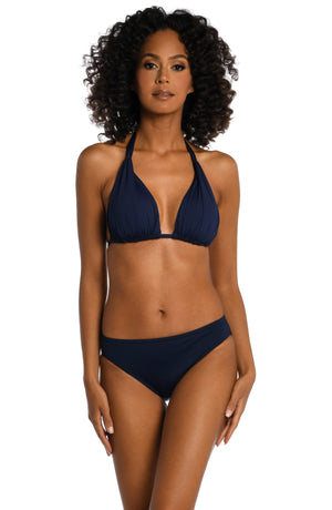 Model is wearing a indigo colored halter triangle swimsuit top from our Best-Selling Island Goddess collection.