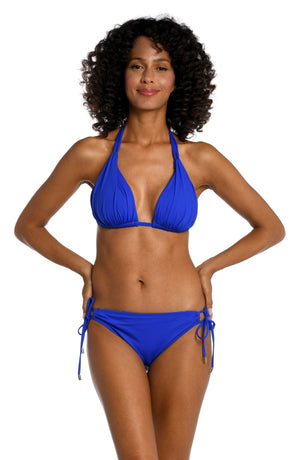 Model is wearing a sapphire colored halter triangle swimsuit top from our Best-Selling Island Goddess collection.