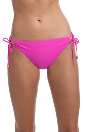 Model is wearing a orchid colored side-tie hipster swimsuit bottom from our Best-Selling Island Goddess collection.
