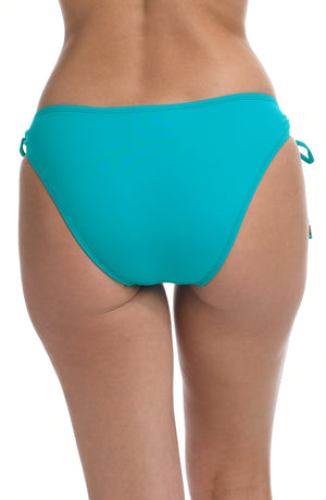 Model is wearing a turquoise colored side-tie hipster swimsuit bottom from our Best-Selling Island Goddess collection.