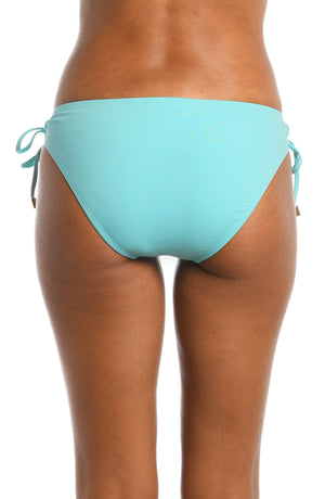 Model is wearing a ice blue colored side-tie swimsuit bottom from our Best-Selling Island Goddess collection.