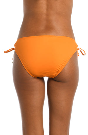 Model is wearing a tangerine colored side-tie swimsuit bottom from our Best-Selling Island Goddess collection.