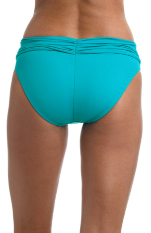 
            
                Load image into Gallery viewer, Model is wearing a turquoise colored shirred hipster swimsuit bottom from our Best-Selling Island Goddess collection.
            
        