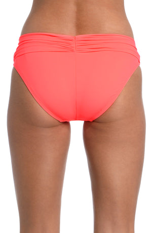 Model is wearing a hot coral colored shirred hipster swimsuit bottom from our Best-Selling Island Goddess collection.