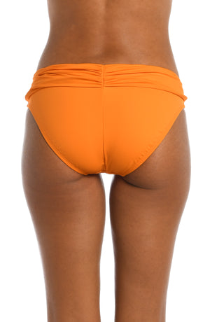 Model is wearing a tangerine colored shirred swimsuit bottom from our Best-Selling Island Goddess collection.