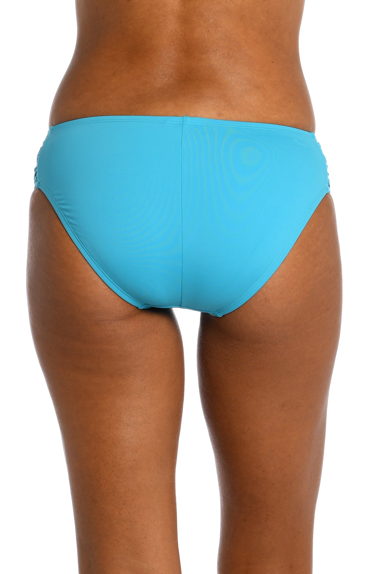 Model is wearing a azul (light blue) colored side shirred swimsuit bottom from our Best-Selling Island Goddess collection.