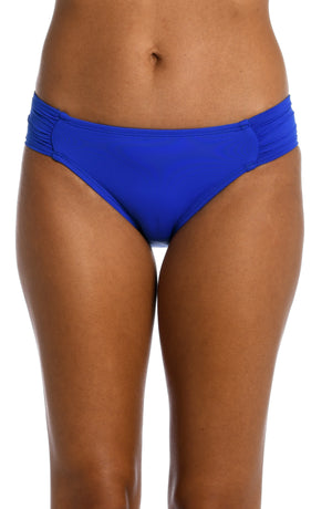 Model is wearing a sapphire colored side shirred swimsuit bottom from our Best-Selling Island Goddess collection.