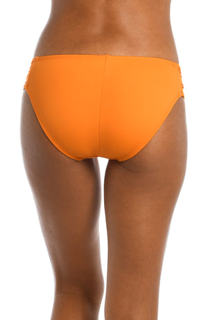 Model is wearing a tangerine colored shirred swimsuit bottom from our Best-Selling Island Goddess collection.