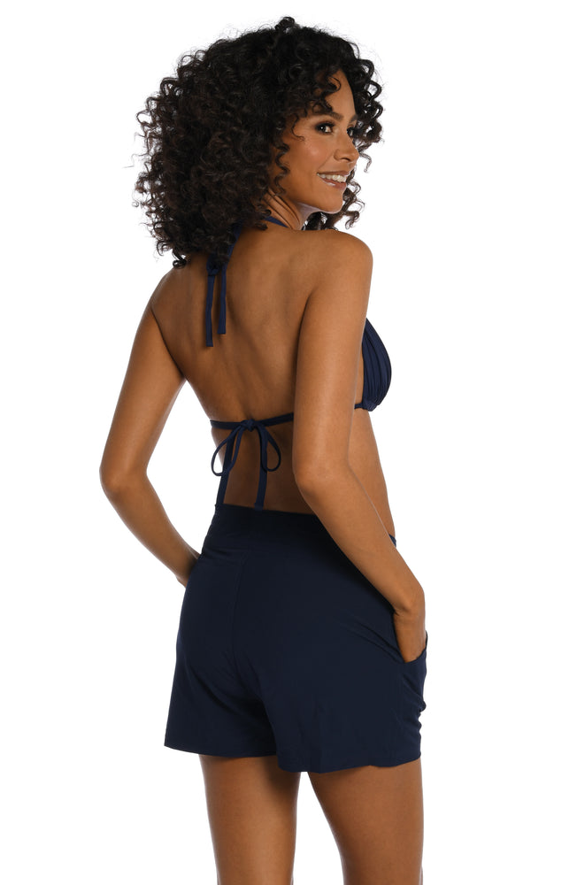Model is wearing a indigo colored board short swimsuit from our All Aboard collection.