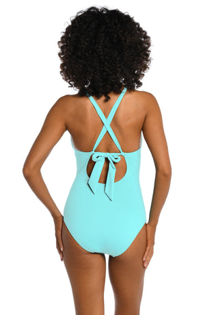 
            
                Load image into Gallery viewer, Model is wearing a ice blue colored high-neck one piece swimsuit from our Best-Selling Island Goddess collection.
            
        