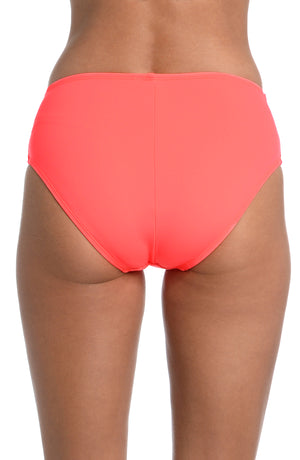 
            
                Load image into Gallery viewer, Model is wearing a hot coral colored mid-waist swimsuit bottom from our Best-Selling Island Goddess collection.
            
        
