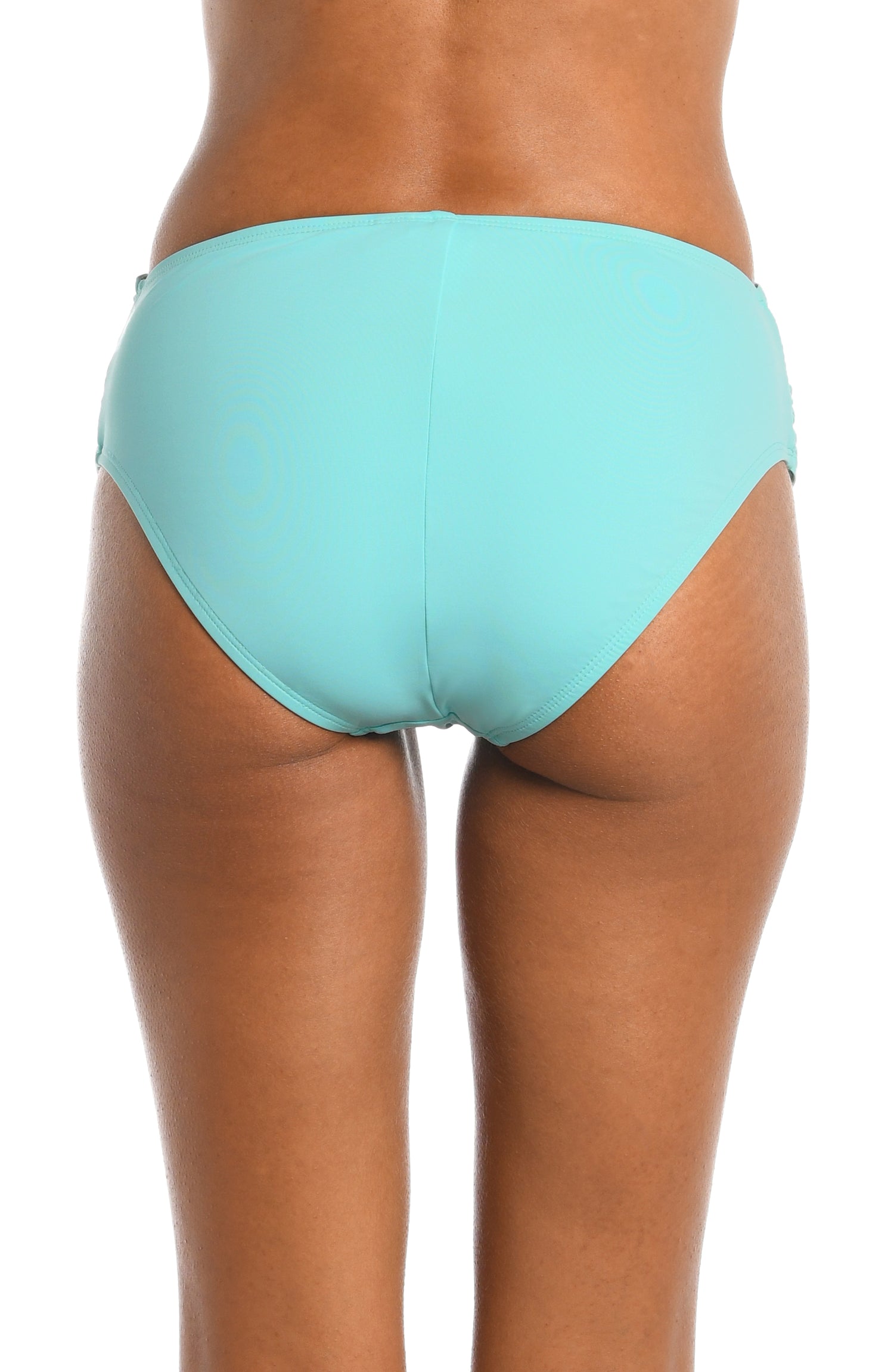 Model is wearing a ice blue colored mid-waist swimsuit bottom from our Best-Selling Island Goddess collection.