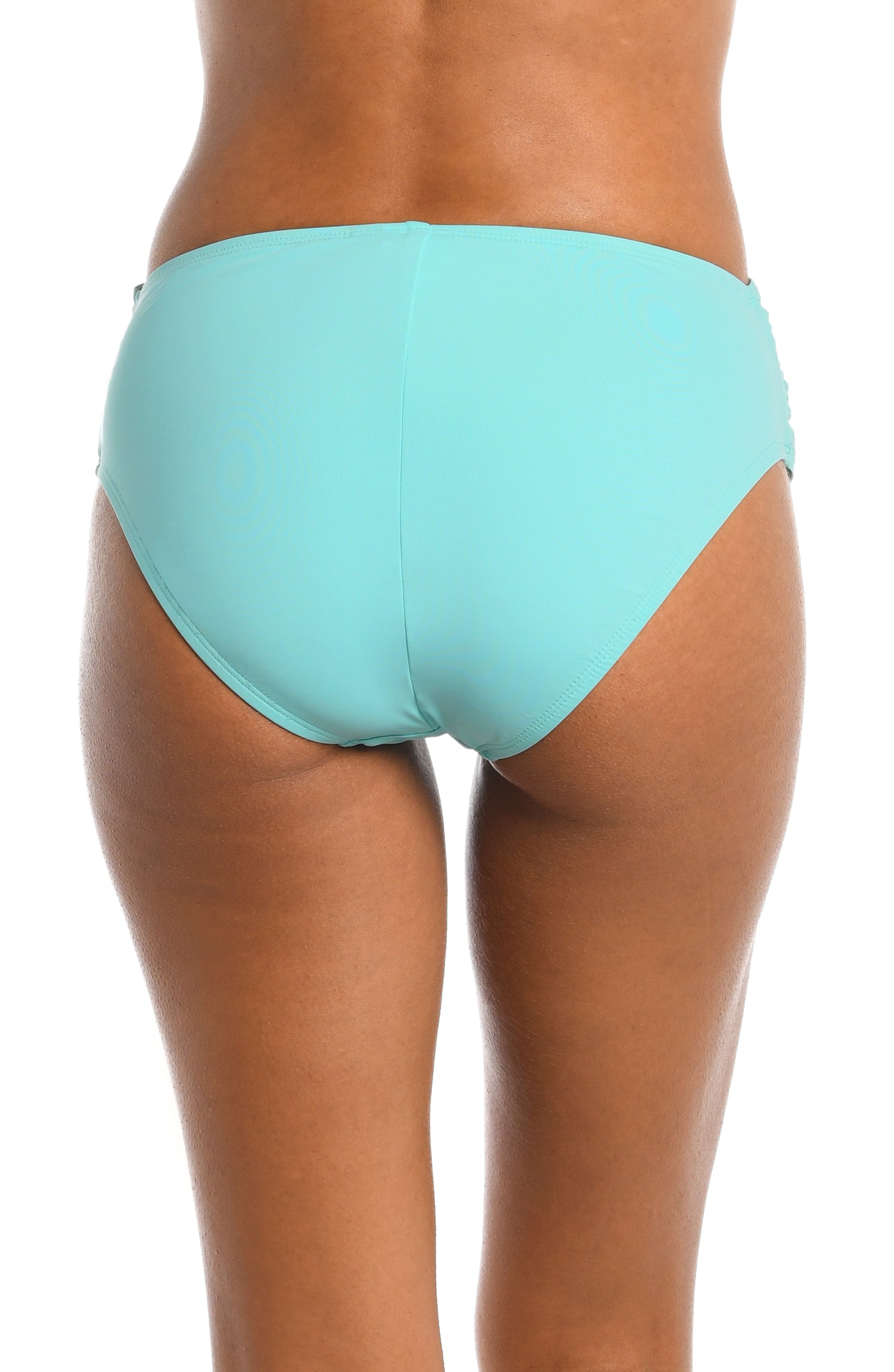 Model is wearing a ice blue colored mid-waist swimsuit bottom from our Best-Selling Island Goddess collection.