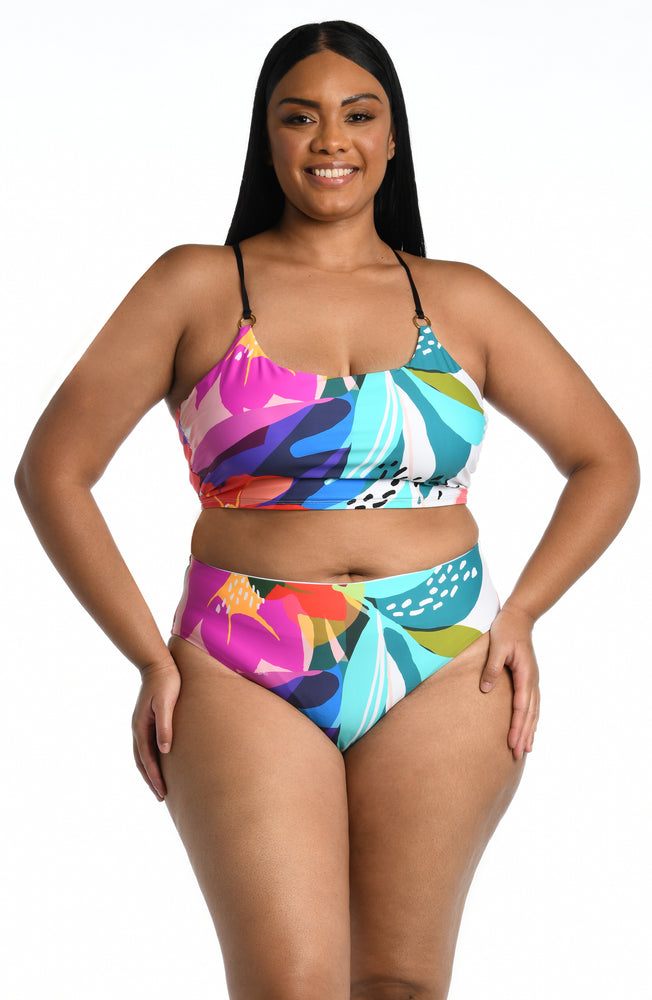 
            
                Load image into Gallery viewer, Model is wearing a multi colored tropical printed midkini swimsuit top from our Eclectic Shore collection.
            
        