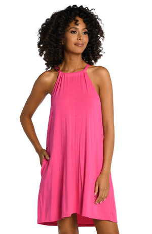 Model is wearing a pop pink colored high neck mini dress swimsuit cover up from our Draped Darling collection.