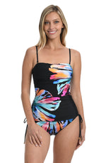 Model is wearing a multi colored tropical fronds printed tankini swimsuit top from our Prism Palm collection.