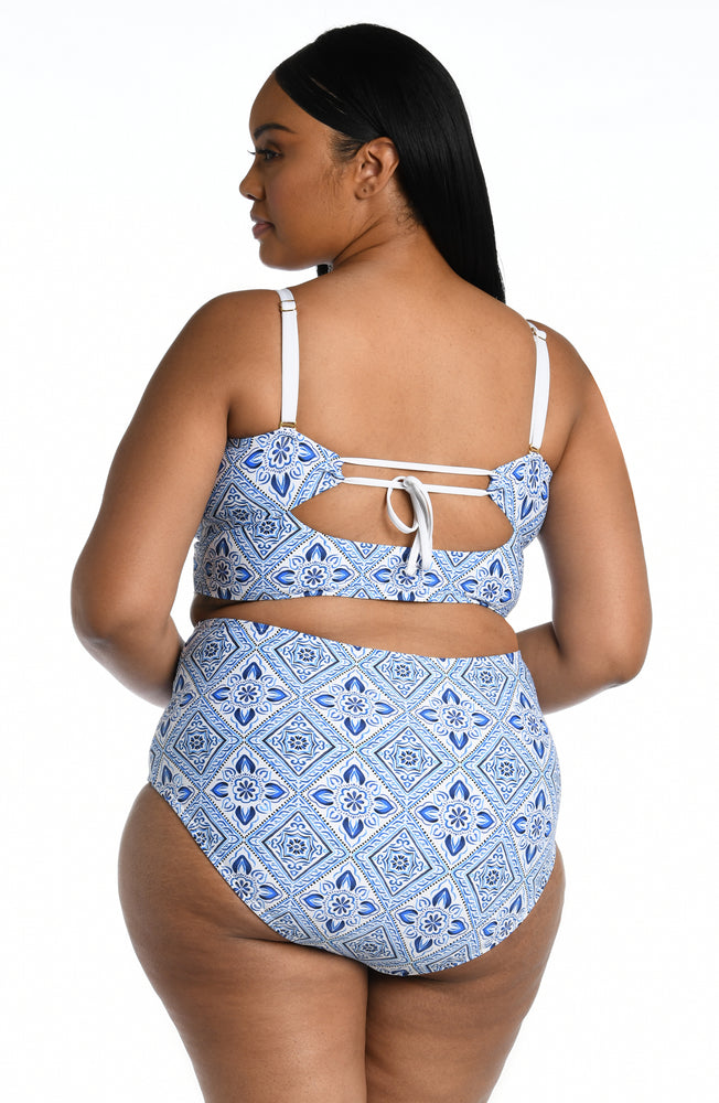 
            
                Load image into Gallery viewer, Model is wearing a light blue artful mosaic printed midkini swimsuit top from our Mediterranean Breeze collection.
            
        