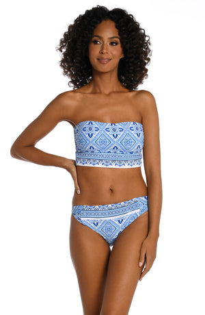 
            
                Load image into Gallery viewer, Model is wearing a light blue artful mosaic printed midkini swimsuit top from our Mediterranean Breeze collection.
            
        