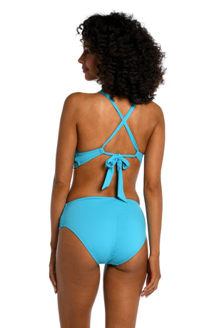 
            
                Load image into Gallery viewer, Model is wearing a azul (light blue) colored midkini swimsuit top from our Best-Selling Island Goddess collection.
            
        