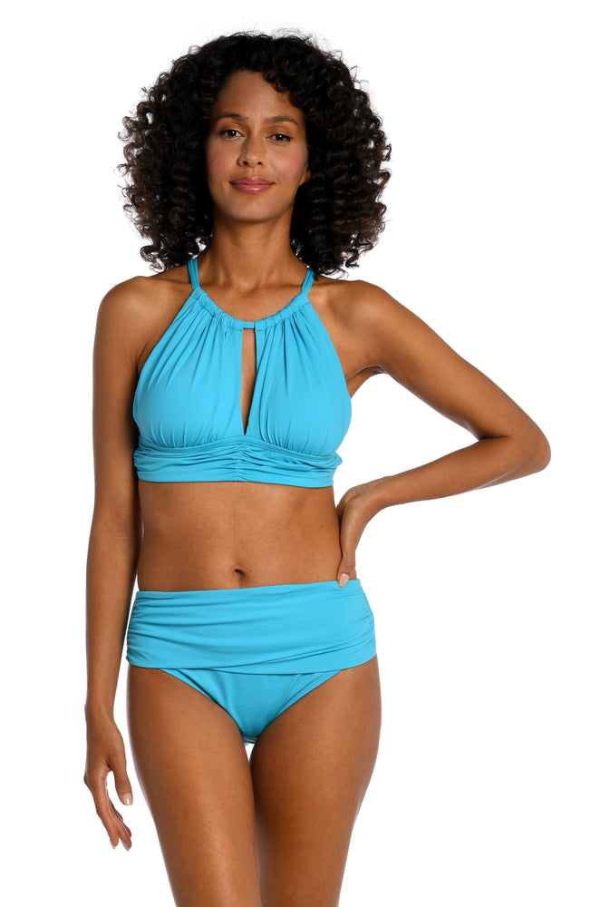 
            
                Load image into Gallery viewer, Model is wearing a azul (light blue) colored midkini swimsuit top from our Best-Selling Island Goddess collection.
            
        