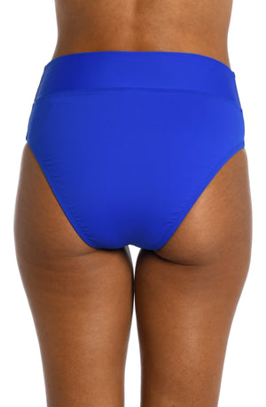 
            
                Load image into Gallery viewer, Model is wearing a sapphire colored high waist swimsuit bottom from our Best-Selling Island Goddess collection.
            
        