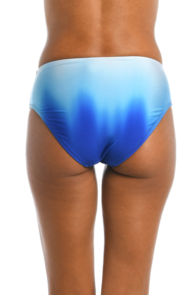 
            
                Load image into Gallery viewer, Model is wearing a sapphire colored ombre printed mid waist bottom from our Ocean Oasis collection!
            
        