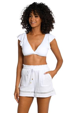 Model is wearing solid white crochet beach shorts from our Seaside Covers collection.