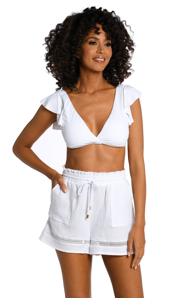 Model is wearing solid white crochet beach shorts from our Seaside Covers collection.