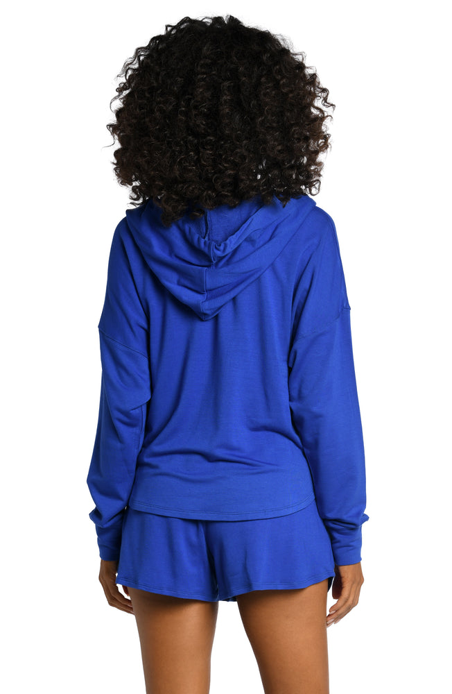 Model is wearing a sapphire colored hooded sweater from our Living in Leisure collection!