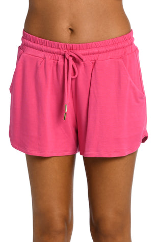 Model is wearing a pop pink colored knitted shorts from our Living in Leisure collection!