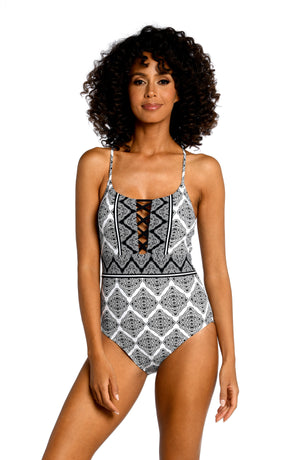 Model is wearing a black and white geometric printed strappy back one piece from our Oasis Tile collection!