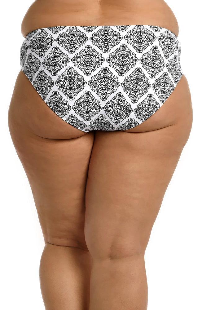 Model is wearing a black and white geometric printed hipster bottom from our Oasis Tile collection!