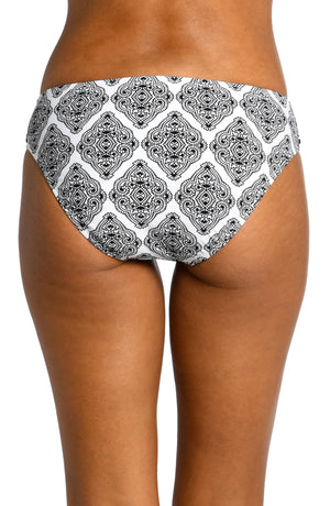 Model is wearing a black and white geometric printed hipster bottom from our Oasis Tile collection!