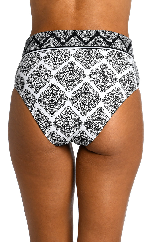 Model is wearing a black and white geometric printed crossover high waist bottom from our Oasis Tile collection!