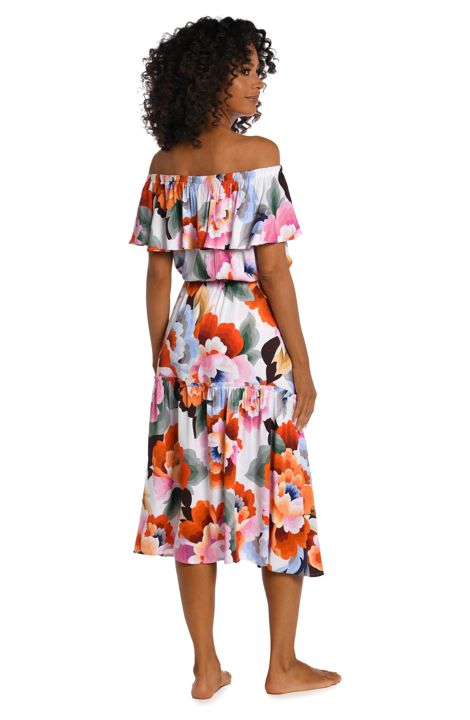 Model is wearing a multi colored floral printed off shoulder cover up dress from our Floral Rhythm collection!