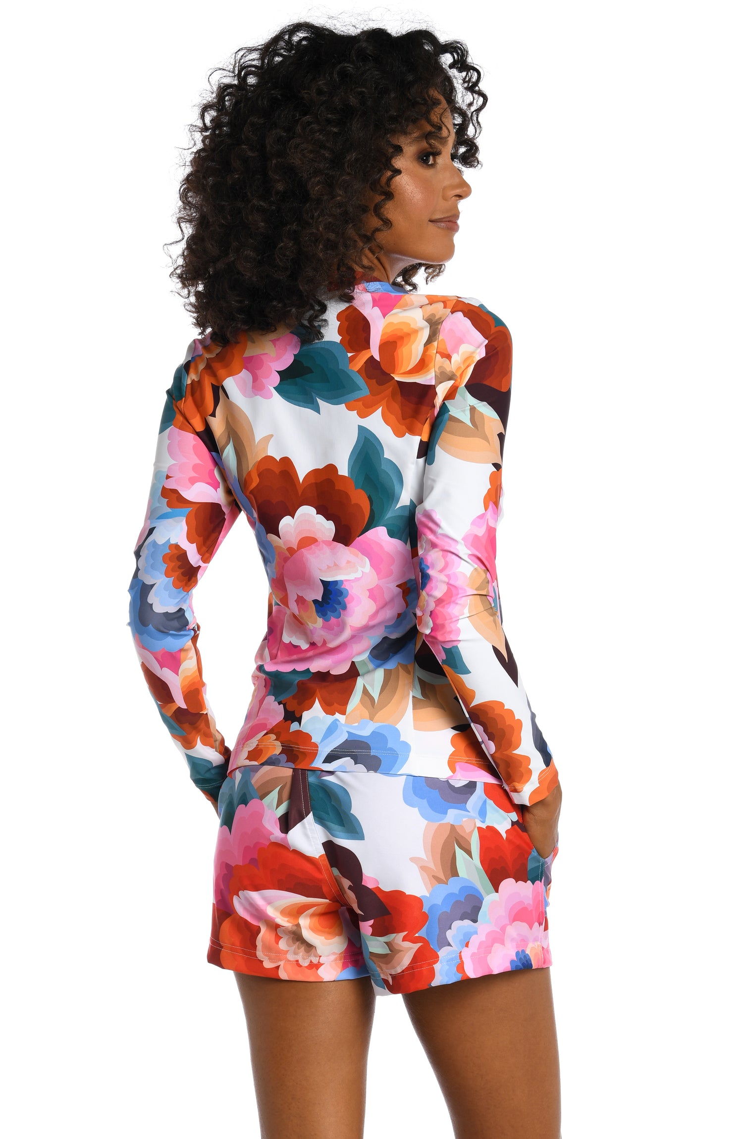 Model is wearing a multi colored floral printed half zip rashguard from our Floral Rhythm collection!