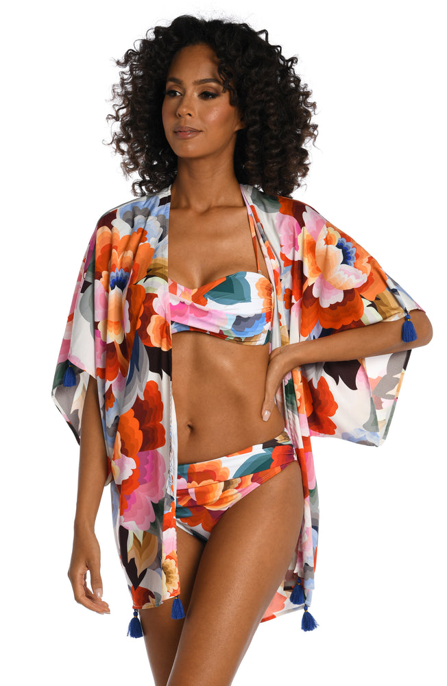 Model is wearing a multi colored floral printed kimono cover up from our Floral Rhythm collection!
