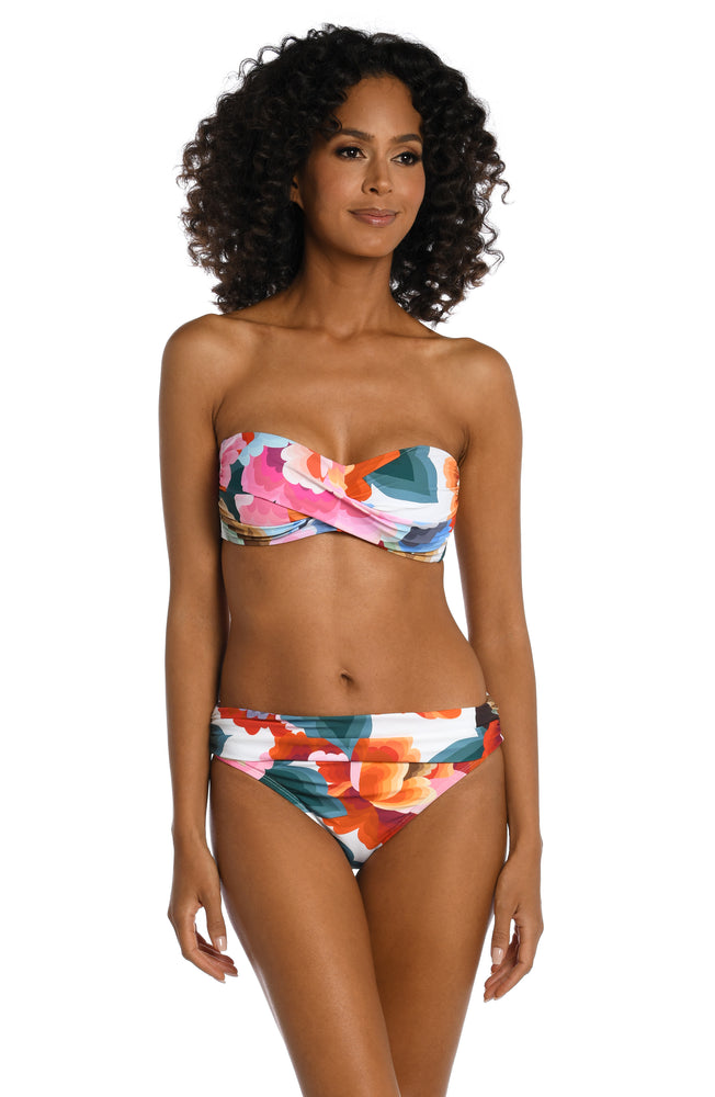 Model is wearing a multi colored floral printed bandeau top from our Floral Rhythm collection!
