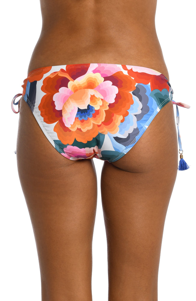 
            
                Load image into Gallery viewer, Model is wearing a multi colored floral printed side tie hipster bottom from our Floral Rhythm collection!
            
        