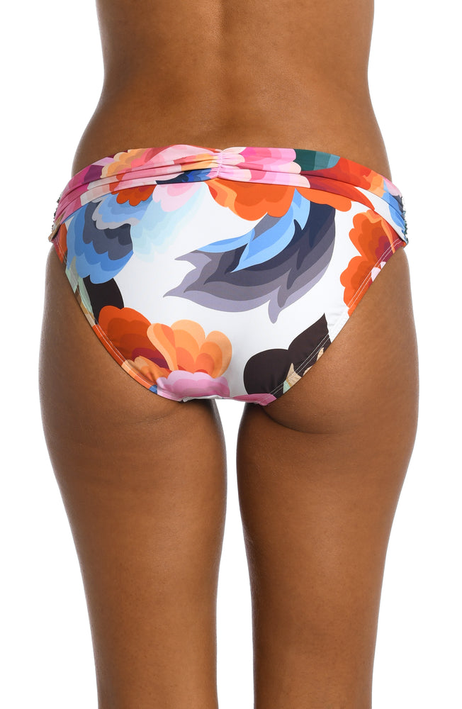
            
                Load image into Gallery viewer, Model is wearing a multi colored floral printed shirred hipster bottom from our Floral Rhythm collection!
            
        