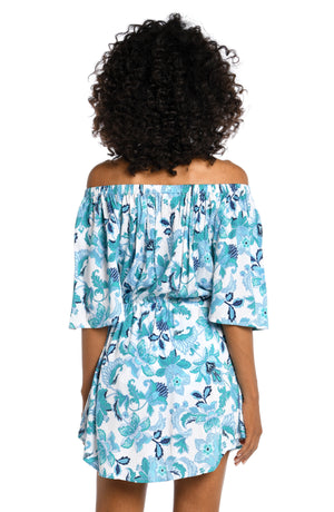 
            
                Load image into Gallery viewer, Model is wearing a light blue multi colored mediterranean printed off shoulder dress cover up from our Santorini Sun collection!
            
        