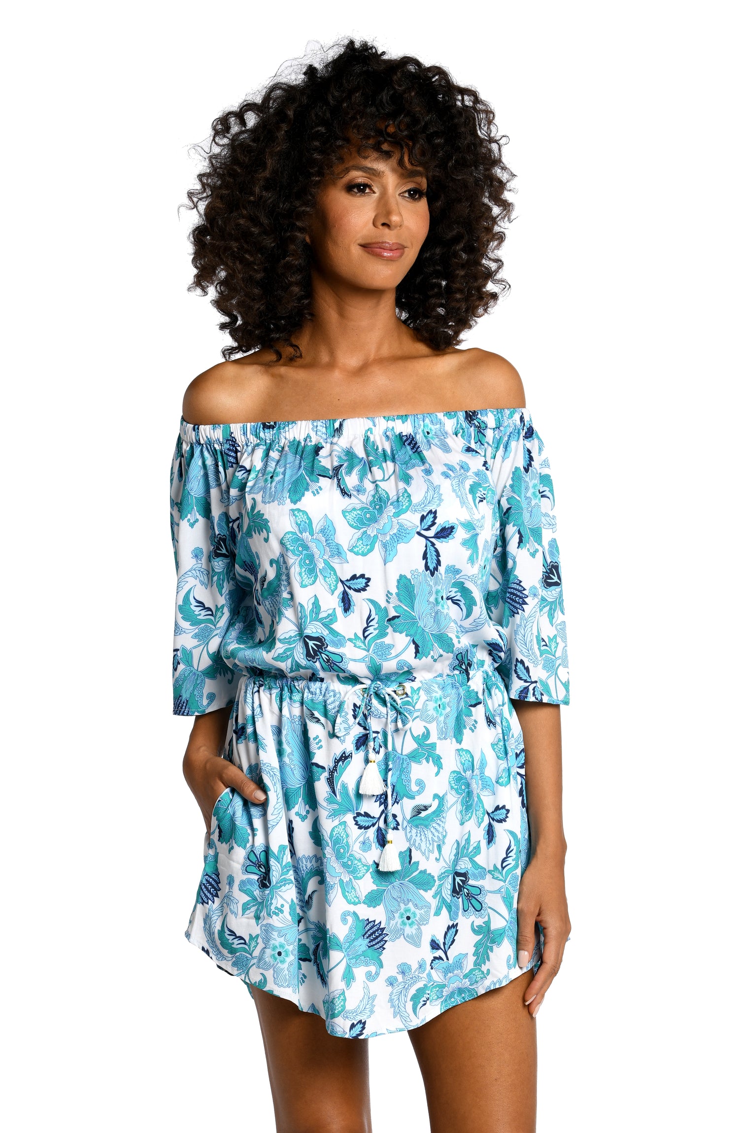 Model is wearing a light blue multi colored mediterranean printed off shoulder dress cover up from our Santorini Sun collection!