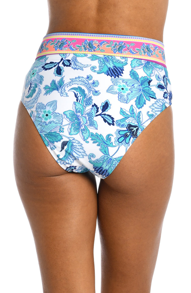 
            
                Load image into Gallery viewer, Model is wearing a light blue multi colored mediterranean printed crossover high waist bottom from our Santorini Sun collection!
            
        
