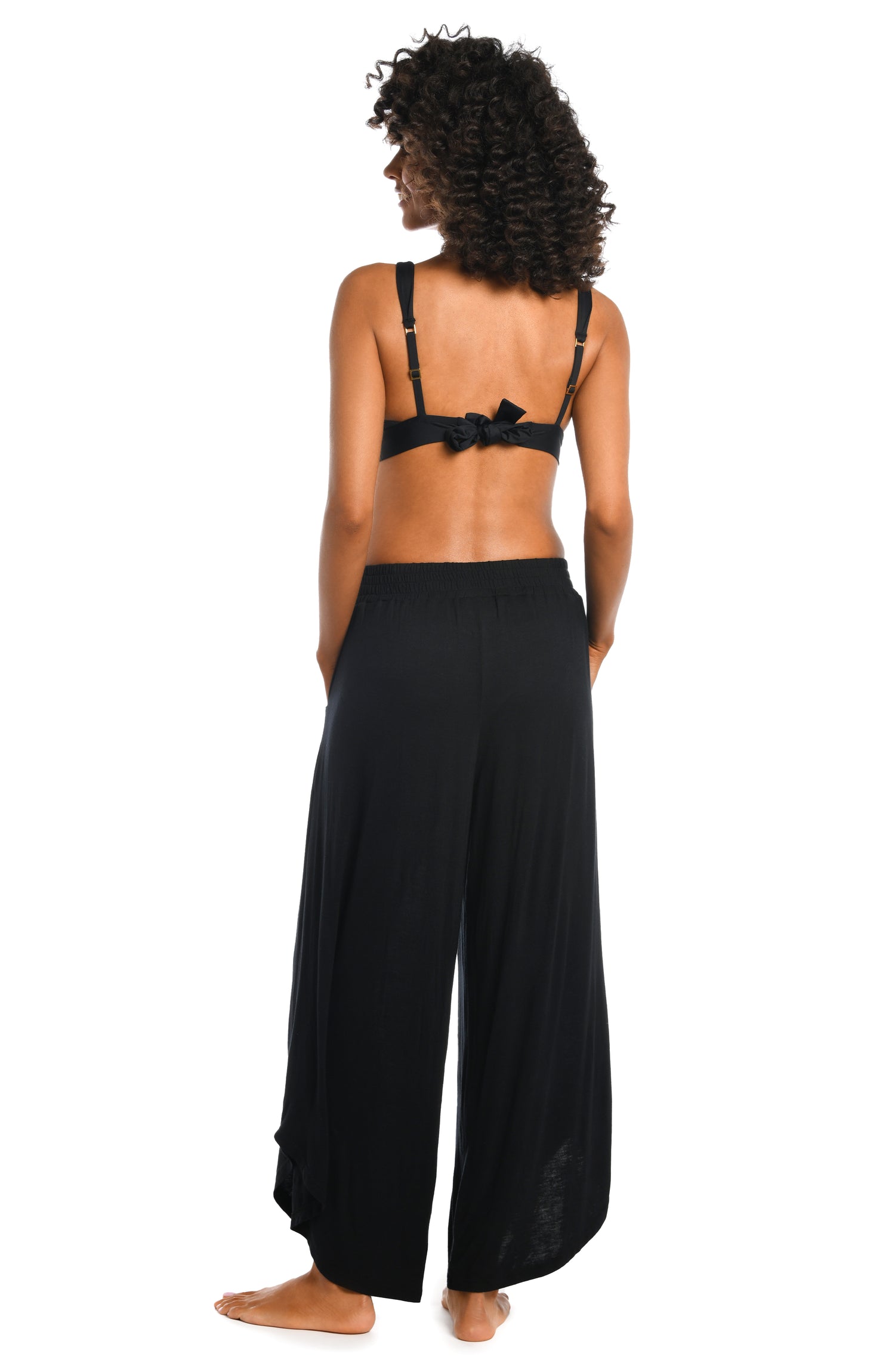 Model is wearing a black palazzo pant swimsuit cover up from our Draped Darling collection.