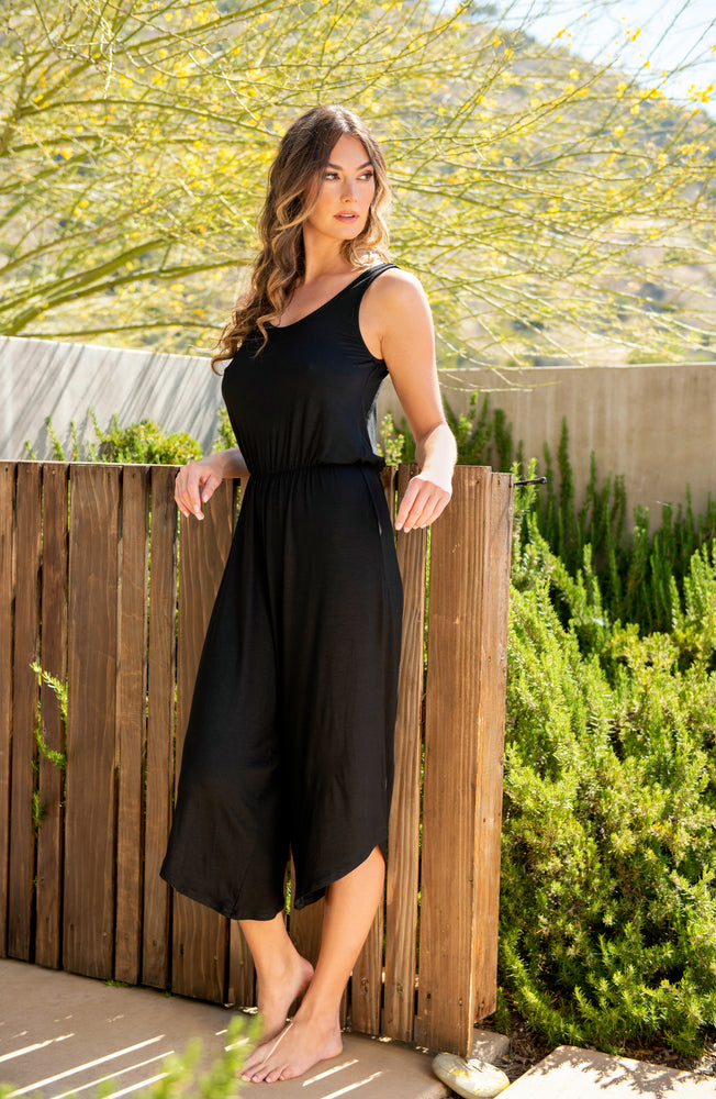 Model is wearing a black jumpsuit swimsuit cover up from our Draped Darling collection.
