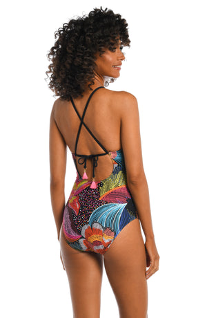 
            
                Load image into Gallery viewer, Model is wearing a shiny multicolored tropical printed high neck one piece from our Sunlit Soriee collection!
            
        