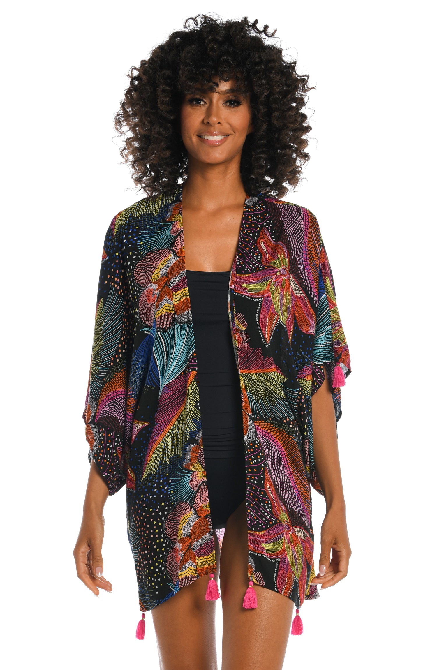 Model is wearing a shiny multicolored tropical printed kimono cover up from our Sunlit Soriee collection!