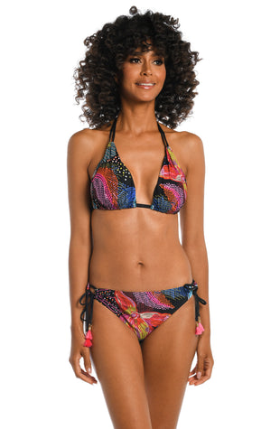 Model is wearing a shiny multicolored tropical printed halter top from our Sunlit Soriee collection!